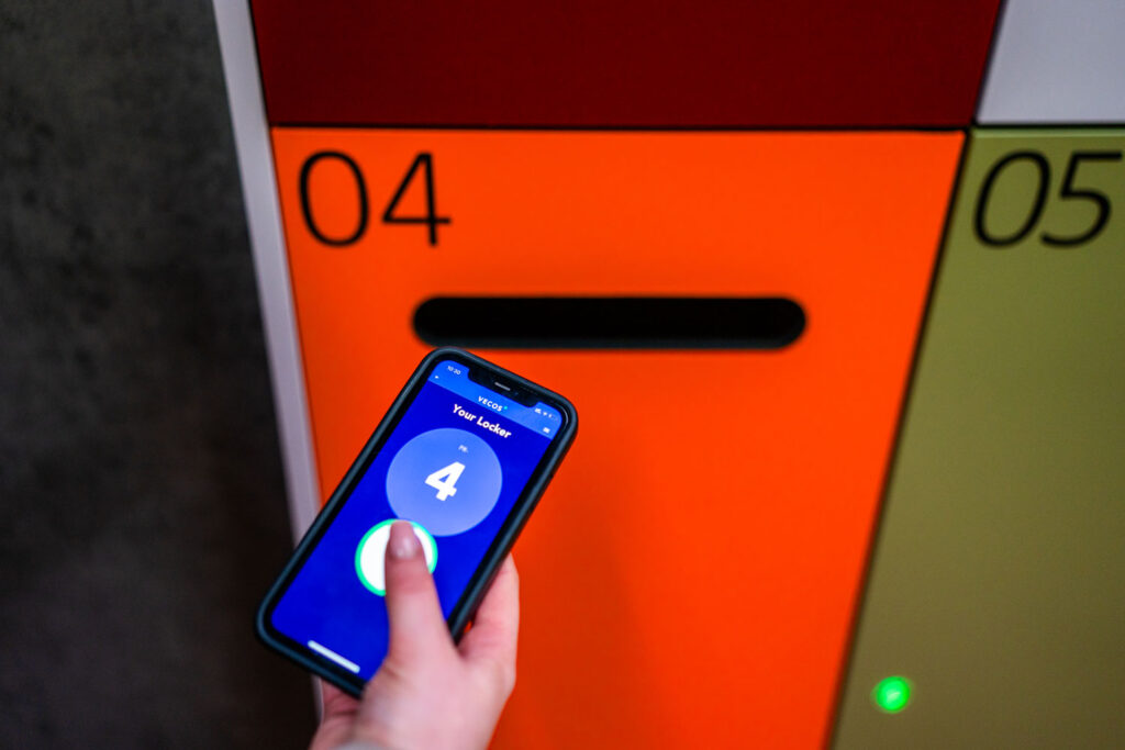 Somebody using a mobile app to access a smart locker.