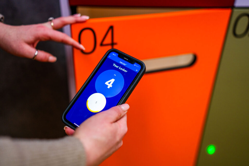 Person using mobile app to access a Simplicity smart locker.