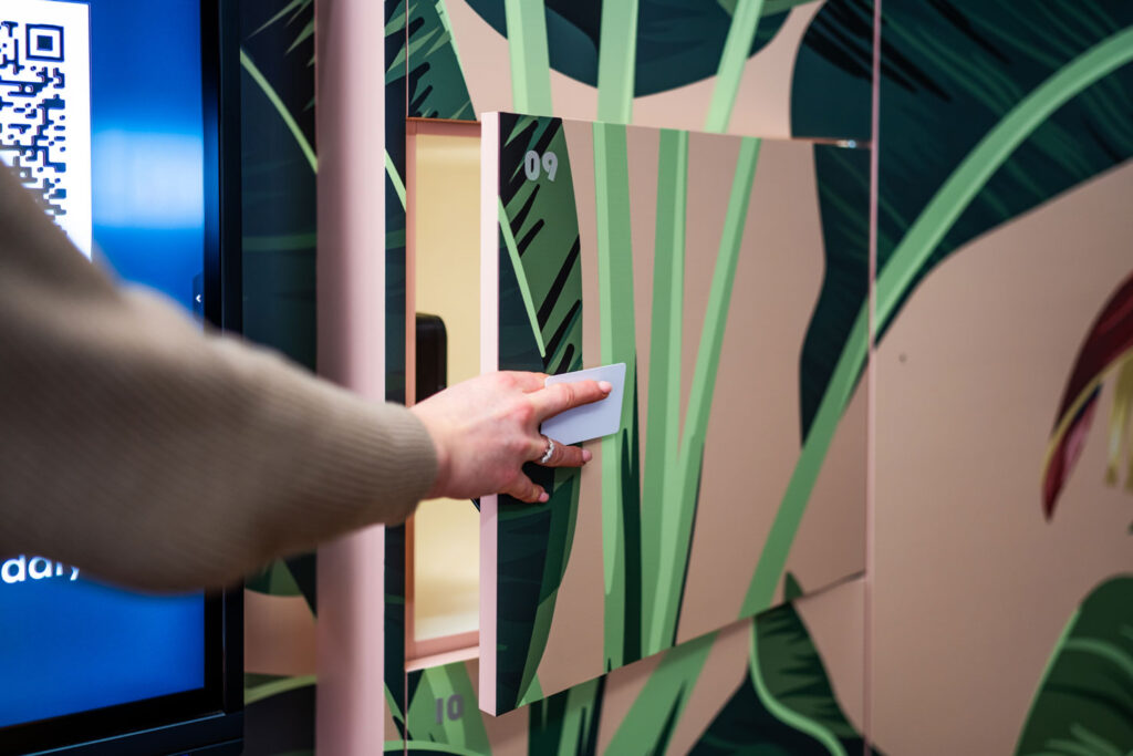 Person opening a Simplicity smart locker with an access card.