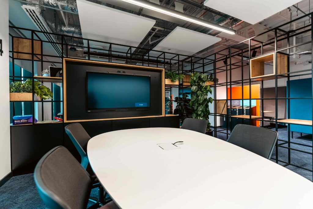 Modular shelving with integrated TV screen for a collaboration area.