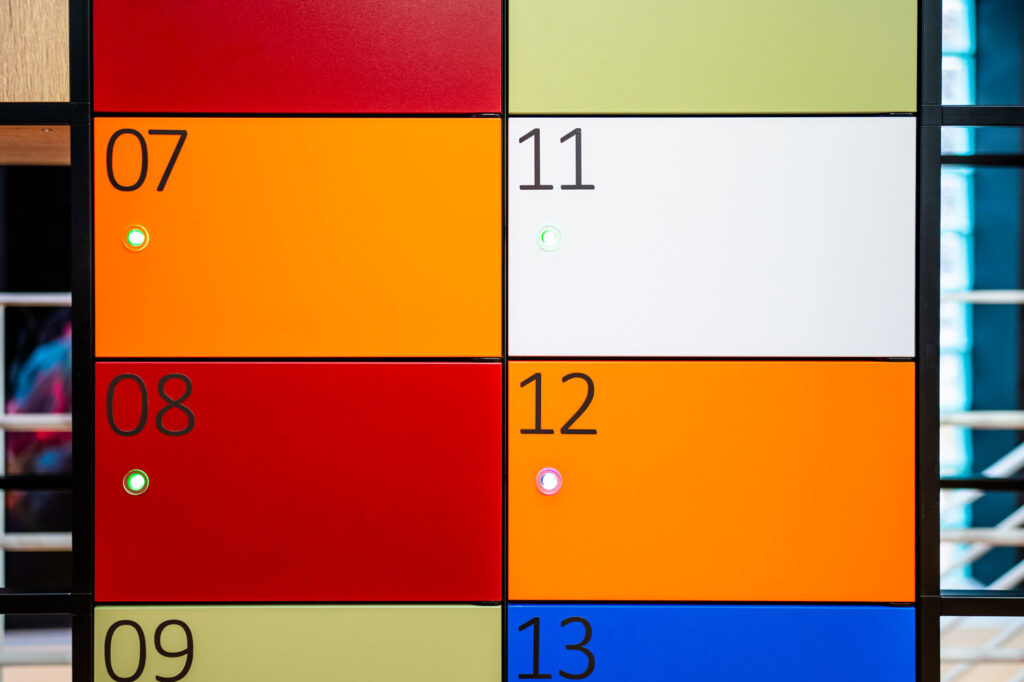 Brightly coloured Simplicity smart lockers with LED indicators in the Your Workspace showroom.
