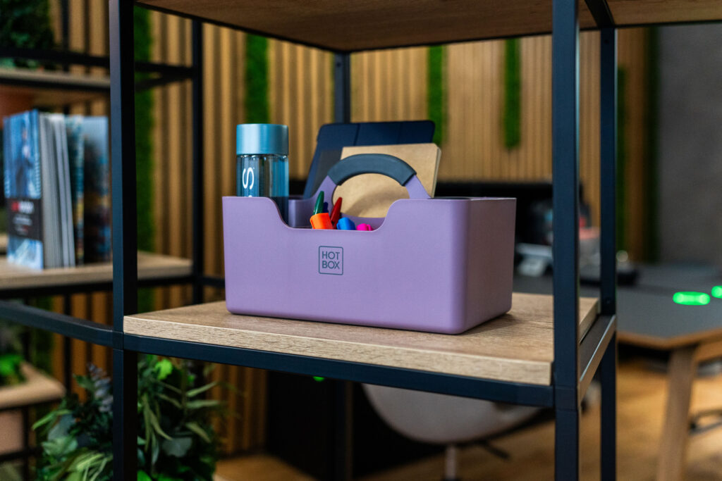 Hotbox caddy for hybrid workers displayed on a modular shelving unit.