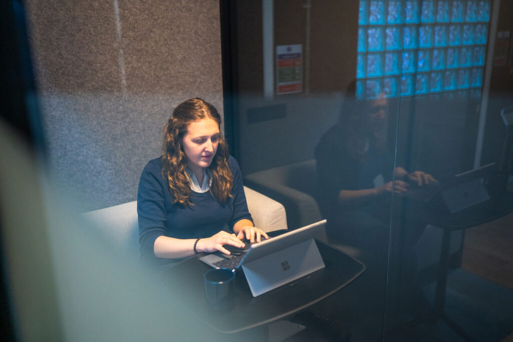Person working on laptop inside a Your Workpod Meet.
