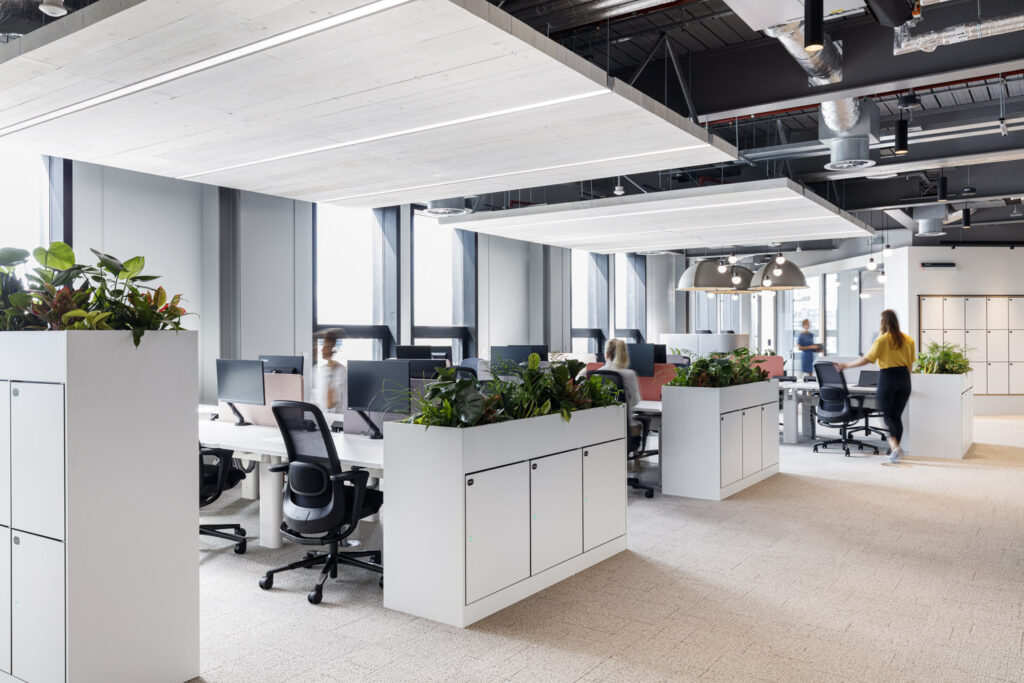 Smart lockers and planters at desk-ends and people working at McKinsey & Co.