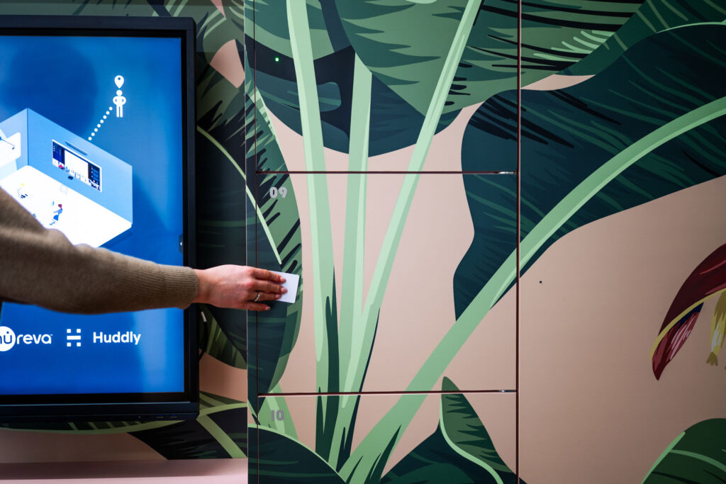 Person using an RFID card to open a Simplicity smart locker in the Your Workspace showroom.