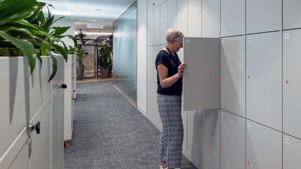 Person opening the door of an office smart locker.